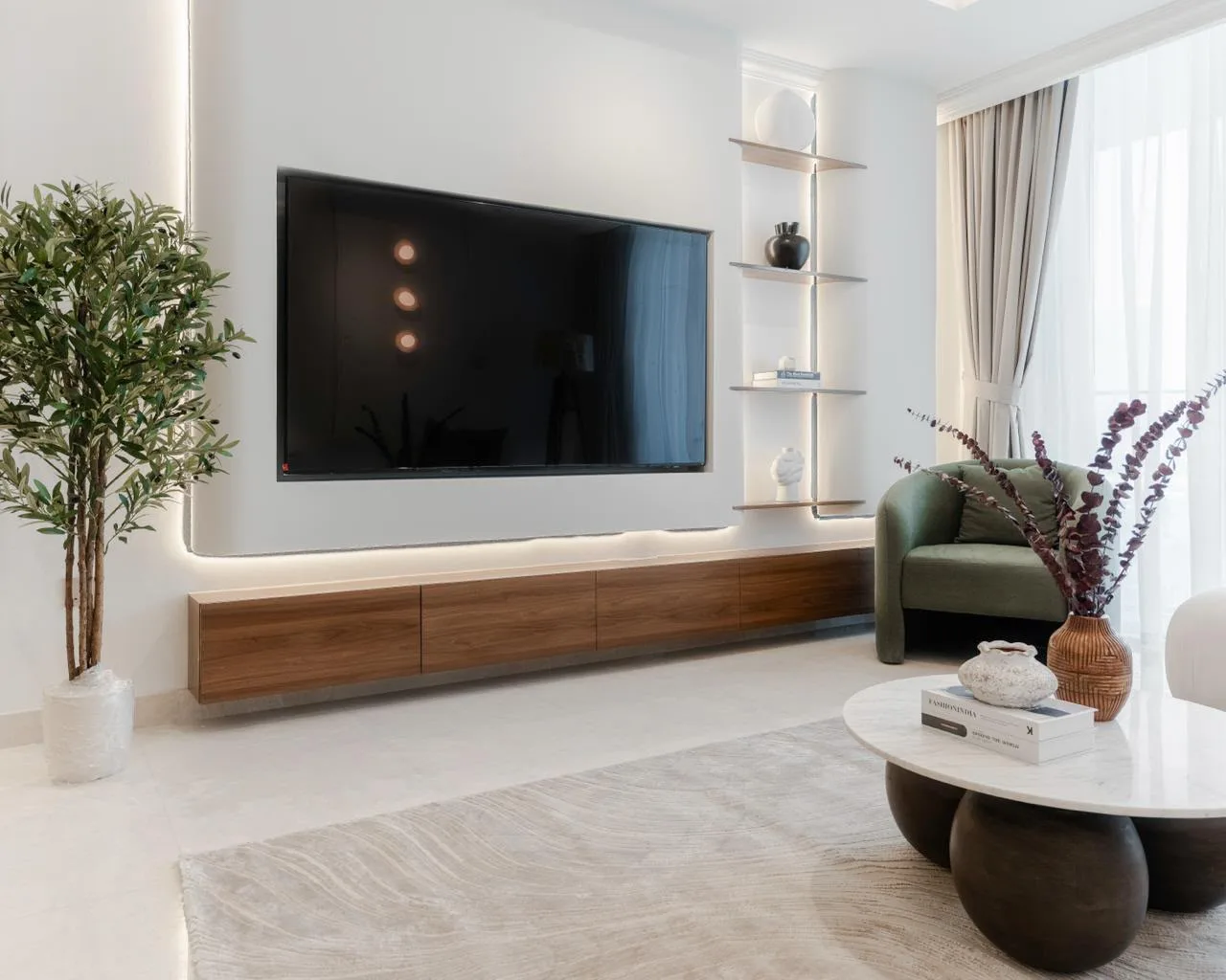 Media feature wall with recessed TV, floating walnut console and LED lighting in Palace Emaar Beachfront