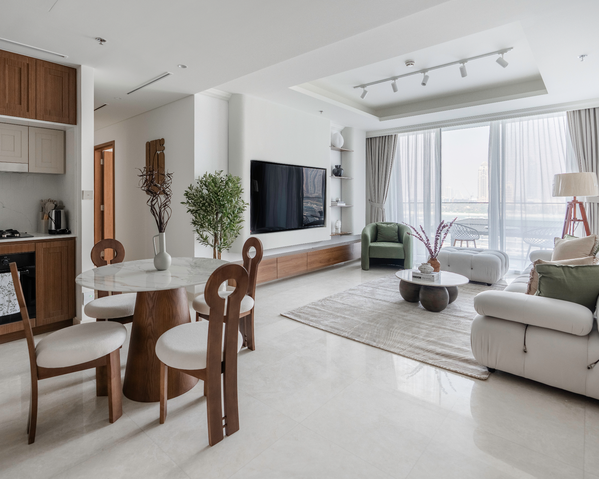 Sophisticated Living Space - Sculptural furniture and warm walnut tones perfectly balanced with elegant coastal views featuring Japandi style interior design by Aziza Home